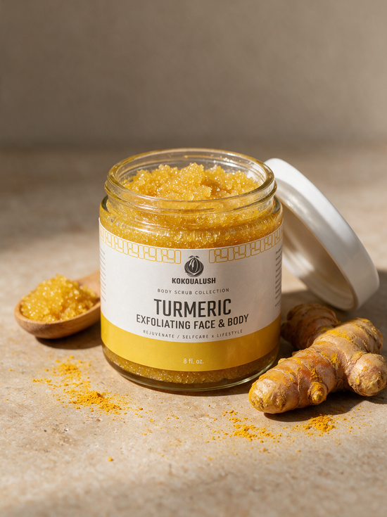 Kokoualush Turmeric Exfoliating Face & Body Scrub in an 8oz glass jar with wooden scoop and turmeric root