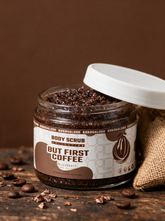 Kokoualush But First Coffee Body Scrub in an 8oz glass jar with roasted coffee beans and burlap
