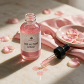 How to use Kokoualush Rub Mi Dung Glow Oil: dropper dispensing on marble with rose petals