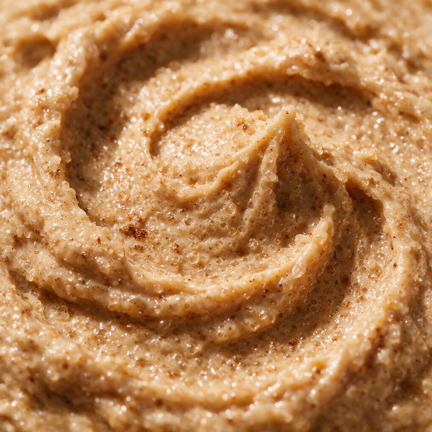Macro texture of pumpkin spice sugar scrub crystals glistening with oil