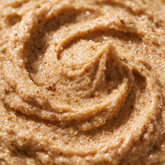 Macro texture of pumpkin spice sugar scrub crystals glistening with oil