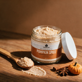 How to use Kokoualush Pumpkin Spice Scrub: open jar with scoop and swatch on wood with cinnamon