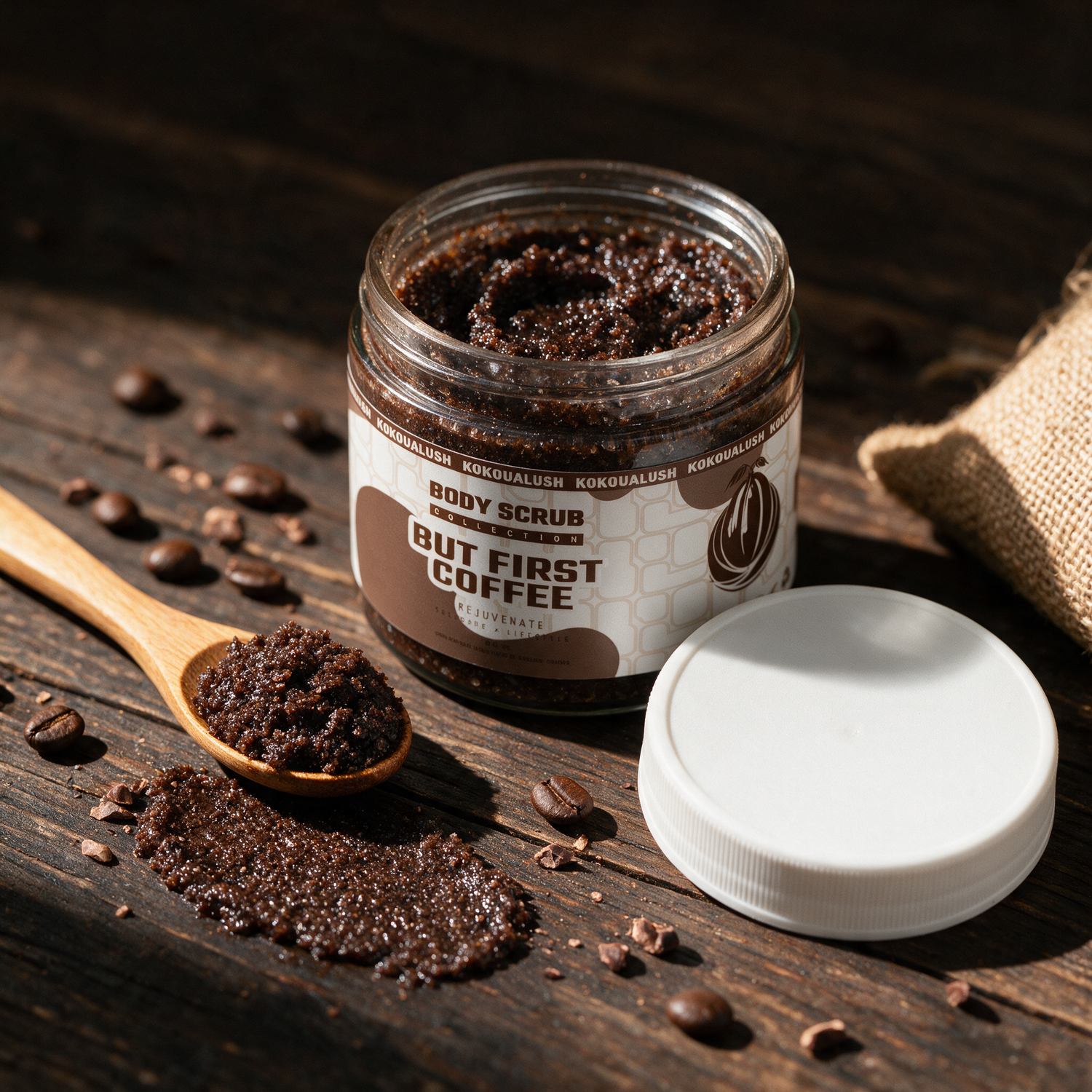 How to use Kokoualush But First Coffee Scrub: open jar with scoop and swatch on wood with coffee beans