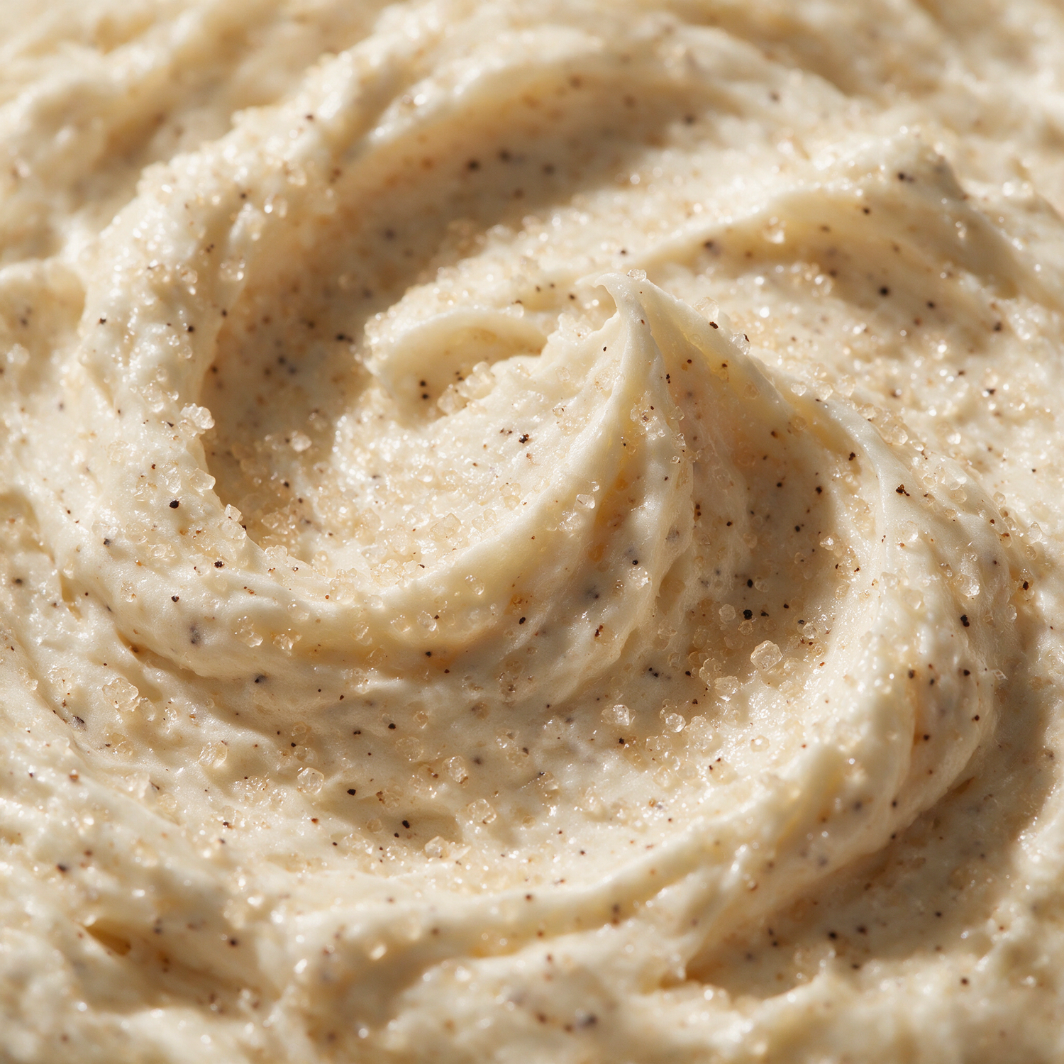 Macro texture of ivory vanilla sugar scrub with vanilla bean specks