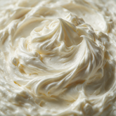 Macro texture of ivory whipped body butter peaks