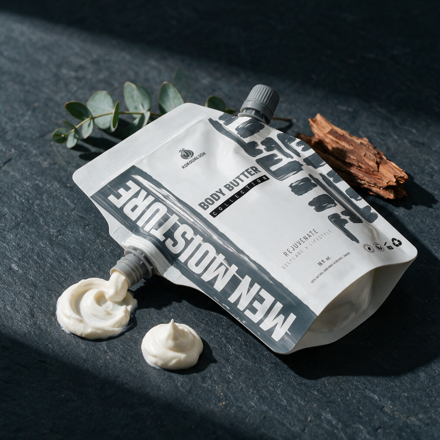 How to use Kokoualush Men Moisture body butter: pouch squeezing a butter swirl on slate
