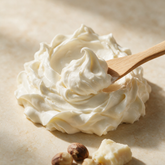 Kokoualush Double Whipped body butter soft swirl on cream stone with raw shea nuts