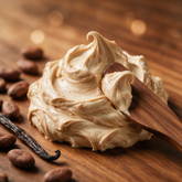 Kokoualush Vanilla Cocoa body butter soft swirl on walnut wood with cocoa beans
