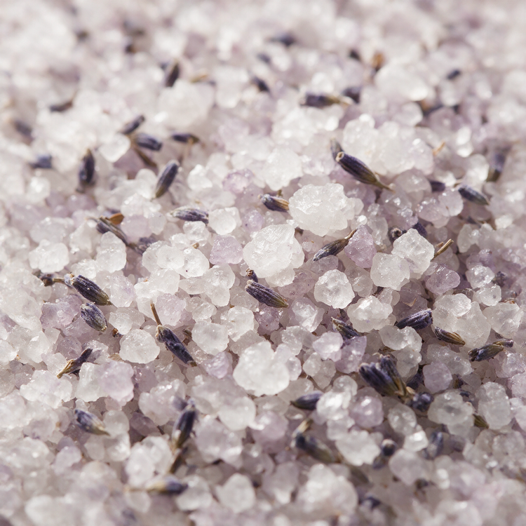 Macro of coarse lavender bath salt crystals with dried buds