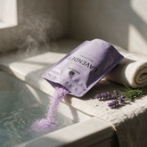 Pouring Kokoualush Lavender bath soak into a warm steamy bath