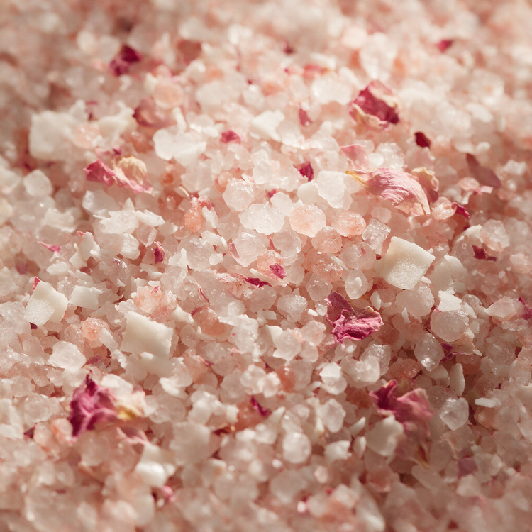 Macro of rose and coconut bath salts with crushed petals