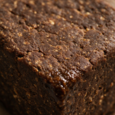 Macro of the raw textured surface of an African black soap bar