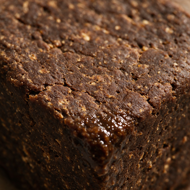 Macro of the raw textured surface of an African black soap bar