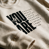 Macro of the sand crewneck fleece and You Are Enough print detail