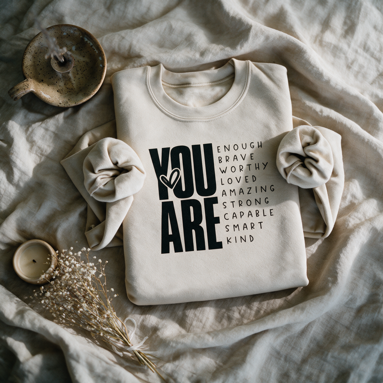 You Are Enough sand crewneck folded and styled with self-care props