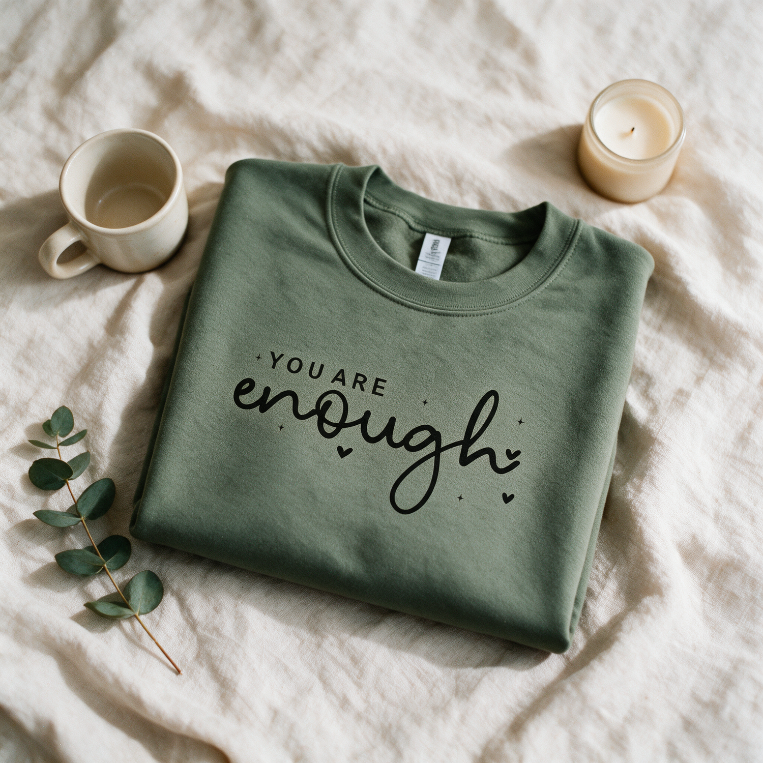 You Are Enough sage crewneck folded and styled with self-care props