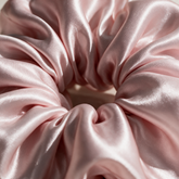 Macro of the lustrous blush pink silk scrunchie fabric
